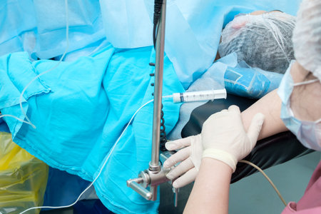 Selective focus on the syringe with anesthesia on the operating table. Administering an anesthetic to a patient during surgery.の写真素材
