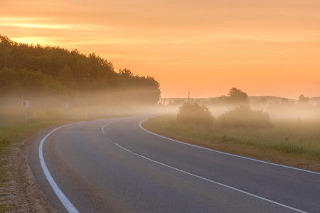 Fog over a suburban highway at dawn. High quality.の写真素材