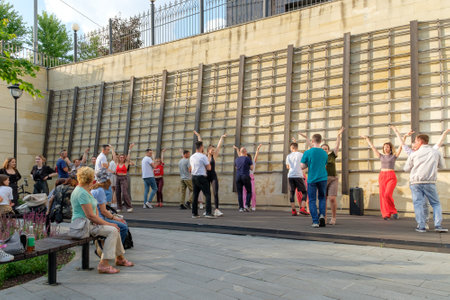 Moscow. Russia. July 1, 2023. Group bachata dance class. People dance Latin American dances on the street dance floor in the park.のeditorial素材