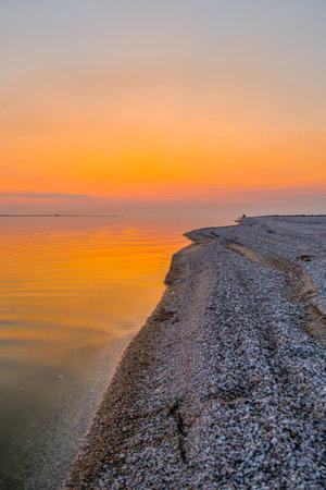 Sandy coastline on the sea at sunset. Sunset seascape.の写真素材