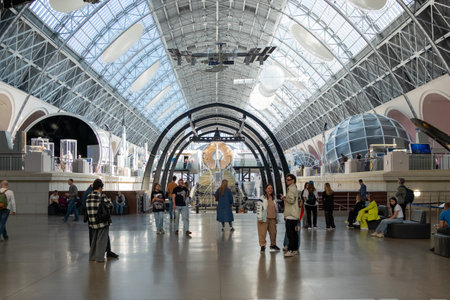 The interior space of the exhibition pavilion Cosmos at VDNKh in Moscow. People viewing exhibits at...
