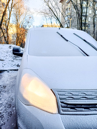 A fragment of a car covered with frost on a winter day. Frozen car.の写真素材