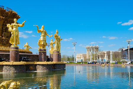 Golden statues of the Friendship of Peoples fountain at VDNKh in Moscow on a sunny spring day. Moscow. Russia. April 23, 2023のeditorial素材