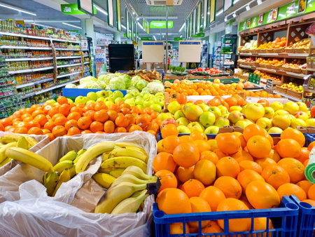 Fresh tangerines, bananas and apples on a supermarket shelf. Fruits on the shelves in a store. Moscow. Russia. February 13, 2024.のeditorial素材
