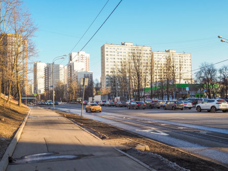 A yellow taxi car drives along a city street on a sunny spring day. Moscow. Russia. March 23, 2024.のeditorial素材