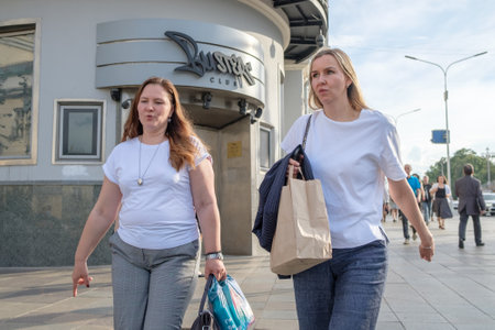 Women pedestrians walk along a city street on a summer day. Moscow. Russia. June 30, 2024.のeditorial素材