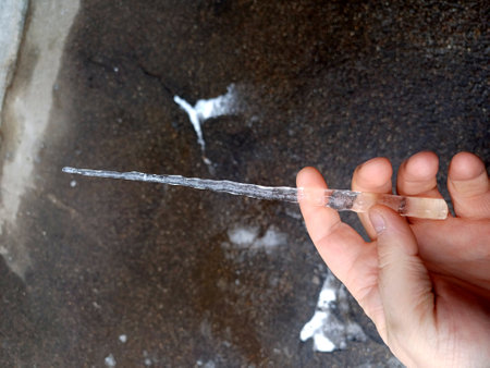 Icicle in a mans hand. High quality photoの写真素材