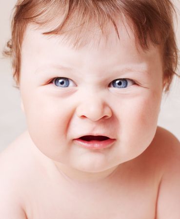 face portrait of very capricious blue-eyed babyの写真素材