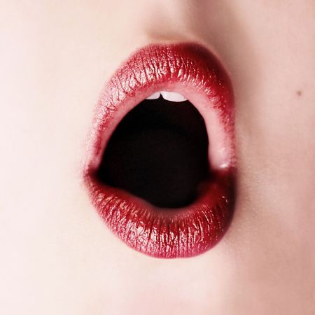 closeup of red sexy lips on woman faceの写真素材