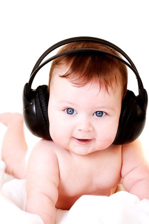 portrait of beautiful smiling baby with earphonesの写真素材