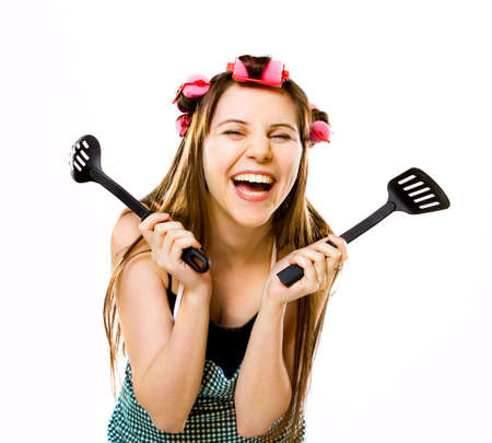 portrait of crazy housewife with kitchen utensilsの写真素材