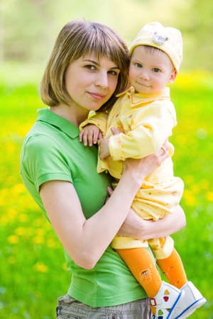mother with baby playing in the parkの写真素材