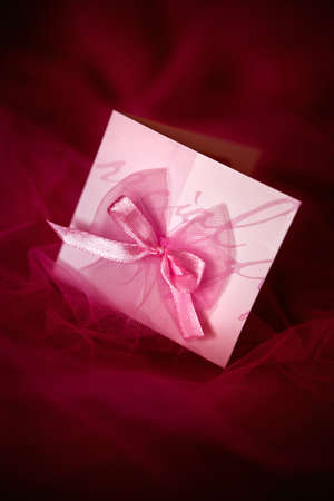 valentine card lying on the red satinの写真素材