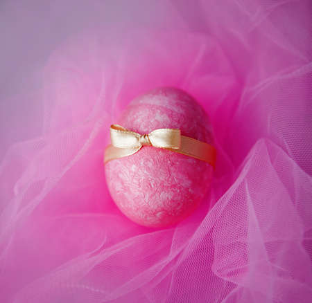 pink egg and green egg on pink textile backgroundの写真素材