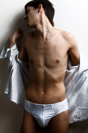 Portrait of a sexy muscular man on gray backgroundの写真素材