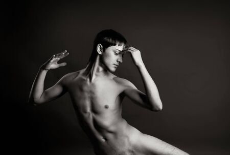 Portrait of a sexy muscular man on black backgroundの写真素材