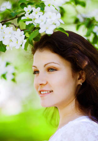 portrait of beautiful woman in the flowering park