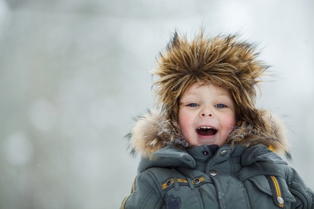 Closeup portrait of happy child in winter hat
