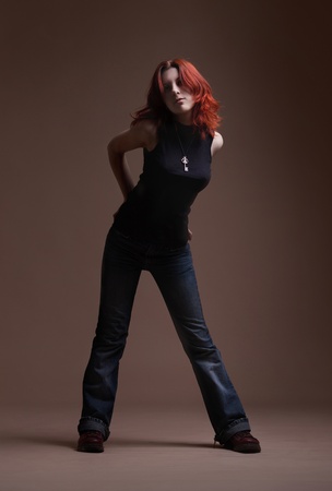 Full-length portrait of fashionable woman on dark backgroundの写真素材