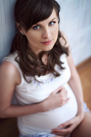 young pregnant woman lying on the sofa