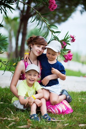Mother with two her children in the parkの写真素材