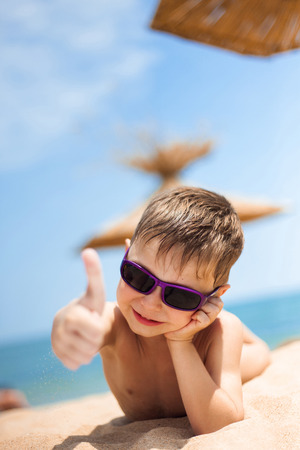Close-up portrait of little boy on the beachの写真素材