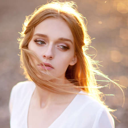 Portrait of beautiful woman in the sunlight raysの写真素材