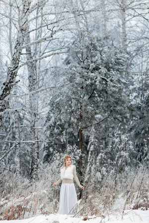 Portrait of beautiful woman in winter forestの写真素材