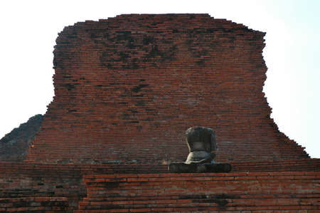 A buddha in front of a crumbling templeの写真素材