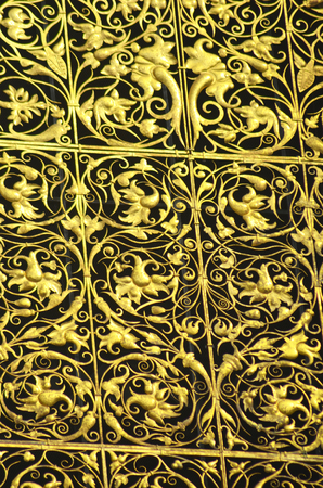 Golden plants twist around one another in exquisite detail on a decorative panel.の写真素材
