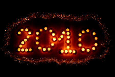 Number 2010 made of candles and surrounded with decorationの写真素材