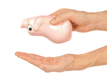 Man holding piggy coin bank upside down to get some coins.の写真素材