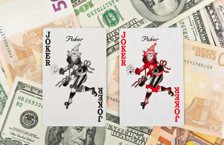 Two jokers over heap of euro and dollarsのeditorial素材