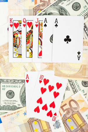 Royal flash in poker game on heap of money