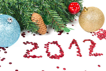 New Year 2012 with christmas balls and branch of fir over white