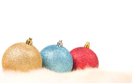 Christmas balls on fur over white background with copy cpaceの写真素材