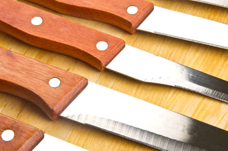 Kitchen knives with wooden handle in a row