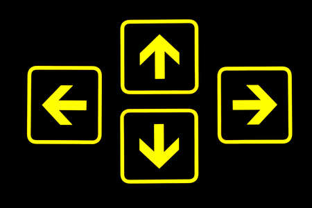 Set of yellow arrow signs over black backgroundの写真素材