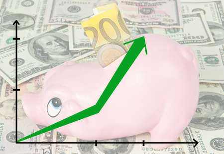 Piggy coin bank and business chart with growing income predictionの写真素材