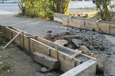 The repair of the road. Pictures of repairing of pedestrian sidewalk. Setting the borderの写真素材