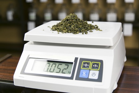 in the tea shop, the seller weighs on the scales teaの写真素材