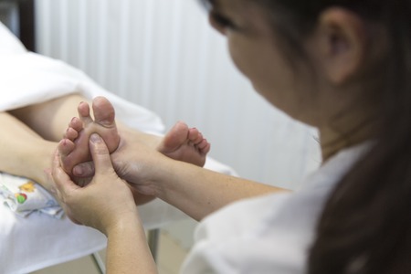 Foot massage. Foot massage in the patient. The doctor does the massage of the feet, heels and toes...