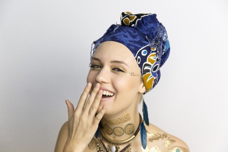 Girl laughs, smiles. A girl in African style clothes with different emotions on her faceの写真素材