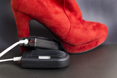 Electric dryer for shoes. Red women's boots are dried using an electric dryer device.の写真素材