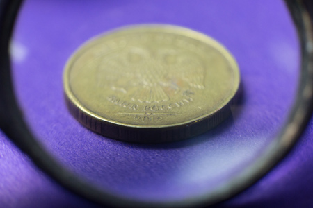 Coins through a magnifying glass. A look at the mettalical money through the increase in the microscope.の写真素材