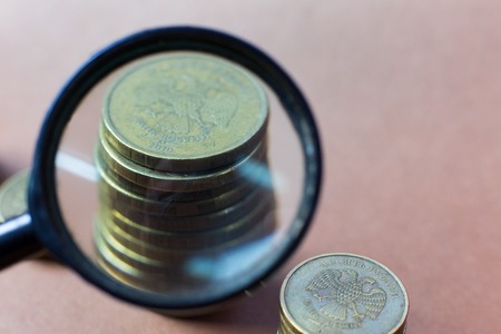 Coins through a magnifying glass. A look at the mettalical money through the increase in the microscope.の写真素材