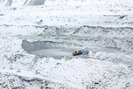Work excavator in the quarry. Open mining with the help of heavy machinery and equipment.の写真素材