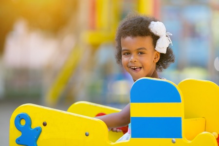 Black girl on the playground. African American girl plays in the playground during the day.