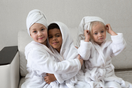 Children having fun after taking a shower.の写真素材