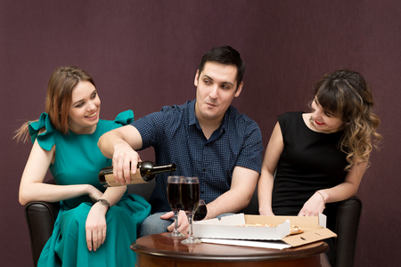 One man in the company of two women party, alcohol.の写真素材